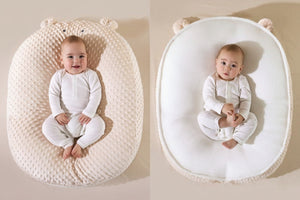Baby in a double-sided Doudou Bear pillow with text indicating different materials on each side.