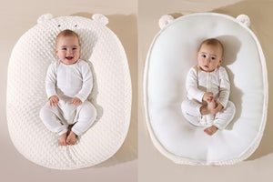 Baby in a double-sided baby nest with different textures on each side.