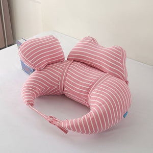 Pink striped U-shaped pillow on a white surface