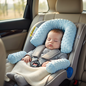 Baby sleeping in a car seat with a blue safety pillow