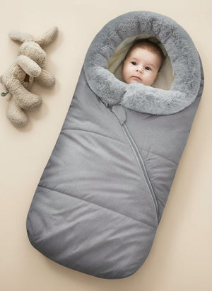 A baby sleeping bag with a gray outer layer, coral fleece middle layer, and a faux fur collar, designed to be windproof and warm.