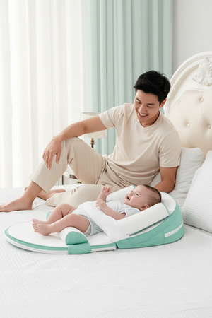 Man sitting on a bed with a baby using a green and white baby support product.