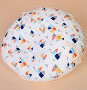 Round baby play mat with colorful geometric pattern on a beige background