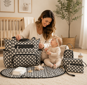 Woman with a baby surrounded by patterned diaper bags in a home setting