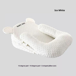 White baby pillow set with U-shaped design on a light gray background