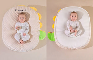 Two views of a baby seat with dinosaur design on a beige background