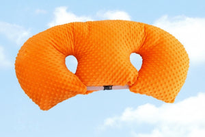 Yellow U-shaped pillow against a blue sky background