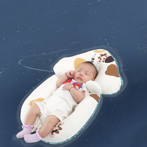 Baby sleeping in a cow-shaped pillow against a starry night sky background