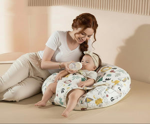 Woman sitting on a bed with a baby using a baby support pillow