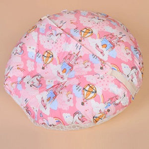 Pink baby seat cover with cartoon designs on a beige background