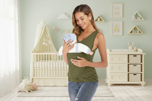 Woman holding a baby in a sling in a nursery
