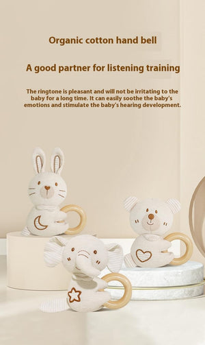 Three organic cotton hand bells shaped like a rabbit, elephant, and bear on a beige background with text about their benefits.