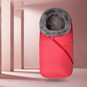 A baby sleeping bag with a gray color and a removable fur collar, zipped into a stroller, keeping the baby warm and protected.