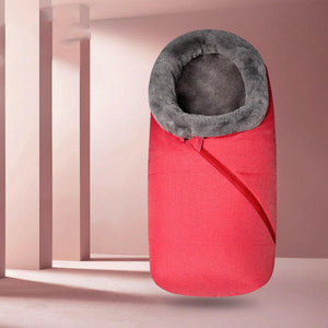 A baby sleeping bag with a gray color and a removable fur collar, zipped into a stroller, keeping the baby warm and protected.
