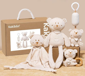Pacification gift box set with teddy bears and baby items on a beige background