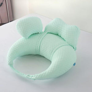 Mint green U-shaped pillow on a white surface