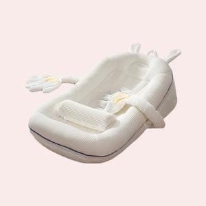 White baby nest with soft texture on a light pink background