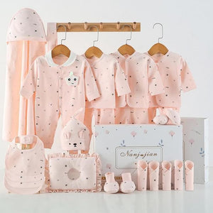 Baby clothing set with pink outfits, accessories, and a canopy on a white background.