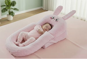 Baby sleeping in a pink bunny-shaped crib in a room with a green wall and white curtains.