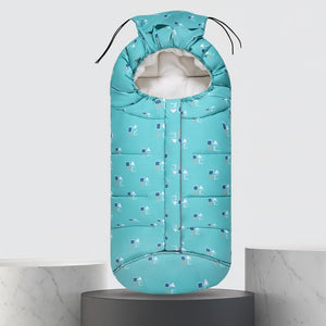 A turquoise baby sleeping bag with a small geometric pattern, shown on a pedestal with dimension markings of 102cm in height and 43cm in width, along with a blue circular graphic indicating suitability for -5 to -10°C autumn and winter.