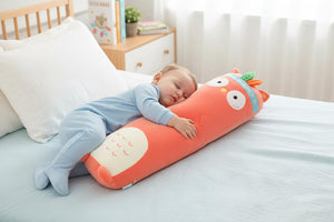 Cute orange plush toy shaped like a cartoon character on a couch