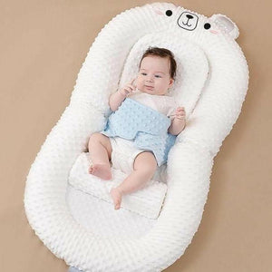 A newborn infant baby lounger bed in pink color, designed with anti-reflux and anti-colic features, including a folding bed in bed mode and an anti-spill milk out feature.