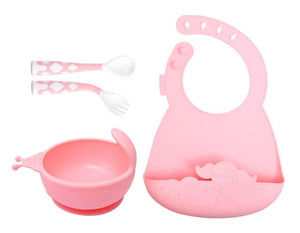 Pink baby feeding set with bib, bowl, spoon, and fork on a white background