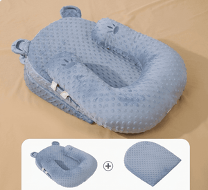 Blue baby nest with a bear design on a beige background