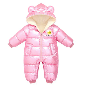 Pink baby snowsuit with hood and smiley face design on a white background