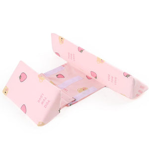 Pink tissue box cover with cartoon designs on a white background