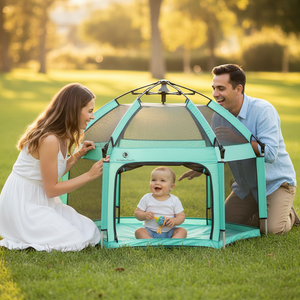 Family with a baby in a green playpen outdoors on a sunny day