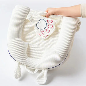 White textured bag with heart design held by a hand on a light gray background