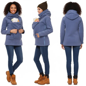 A collage of three images showing a woman modeling a black kangaroo hoodie with a baby inside the kangaroo pocket. The hoodie is designed for hands-free carrying of a baby.