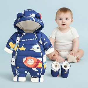 Baby in a blue space-themed snowsuit with matching shoes on a light blue background