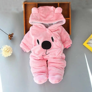 A beige Disney Winnie-the-Pooh winter jumpsuit for babies, featuring a hood with ears, footed design, and a smiling Winnie-the-Pooh face on the front.