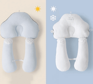 A baby lying on a white, solid patterned sleep pillow designed for infants.
