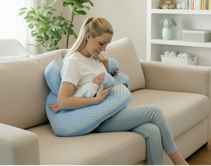 Woman holding a baby with a blue pillow