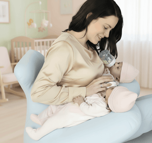 Woman feeding a baby with a bottle in a nursery setting