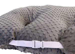 Gray textured pillow with a white strap on a white background