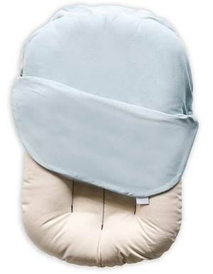 Baby head support pillow with light blue cover on a white background