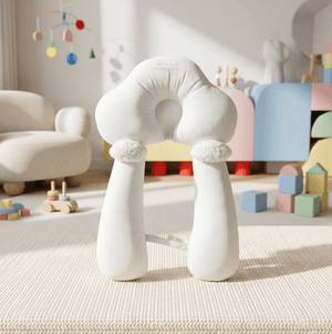 White cloud-shaped chair in a playroom with toys and a colorful mobile.