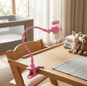 Pink lamp with a bottle attachment on a wooden table in a room with a crib and toys.