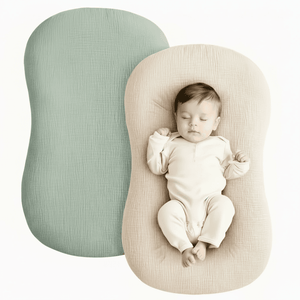 Baby lying on a soft, rounded pillow with a plain background