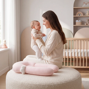 Woman holding a baby in a nursery with a crib and shelves in the background