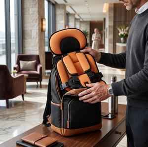 Man holding a black and orange backpack with a child's car seat inside in a modern interior setting.