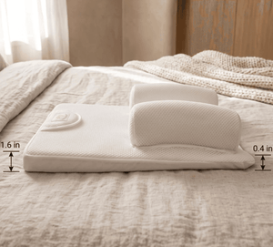 A white ergonomic mattress topper with a built-in headrest and a small built-in remote, displayed on a beige textured bed. Dimension overlays indicate a height of 1.