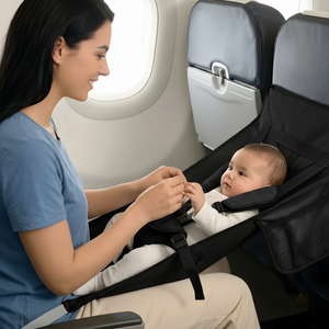 Woman sitting in an airplane seat with a baby in a high chair