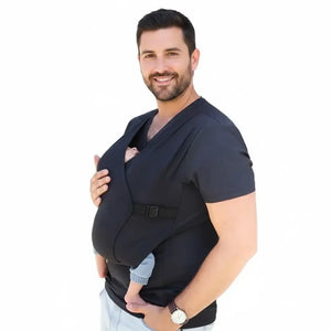 A man wearing a black T-shirt baby carrier with a baby in it.