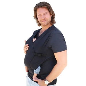 A man wearing a black T-shirt baby carrier with a baby in it.