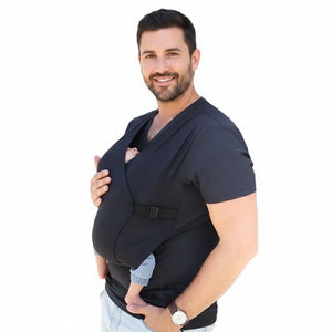A man wearing a black T-shirt baby carrier with a baby in it.